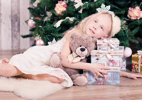 child with Christmas gifts